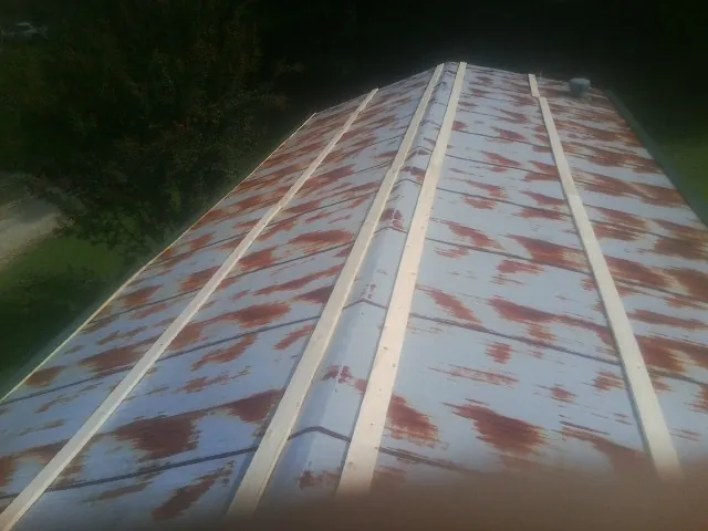 Rusted metal roof panels with new wood purlins before replacement — Storm Damage Roof Repair in Red Boiling Springs by Roofing Brothers