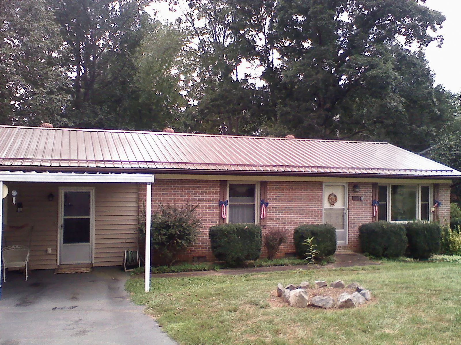 Bronze metal roof and carport on a brick ranch home — Roof Repair work by our crew in Red Boiling Springs